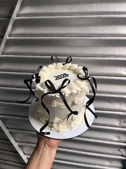 New Years White Cake With Black Bow Victorian Cake