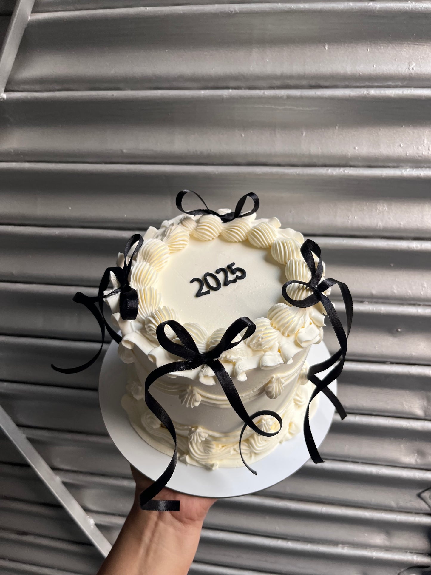New Years White Cake With Black Bow Victorian Cake